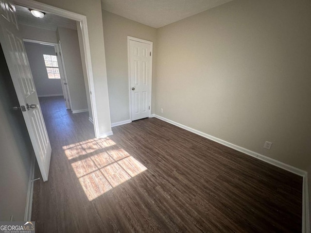 spare room with dark hardwood / wood-style flooring