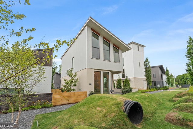 rear view of property with a lawn