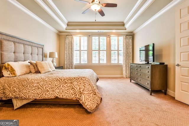 bedroom with a raised ceiling, ceiling fan, crown molding, and light carpet