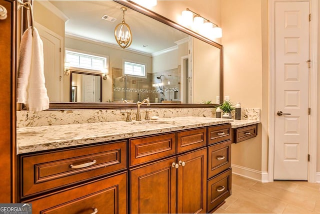 bathroom featuring tile patterned floors, crown molding, vanity, and tiled shower