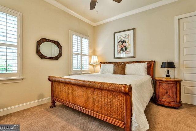 carpeted bedroom with ceiling fan and ornamental molding