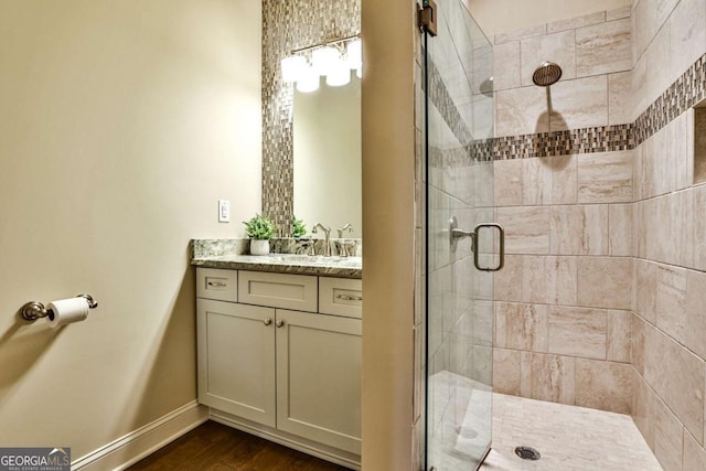 bathroom featuring hardwood / wood-style floors, vanity, and an enclosed shower