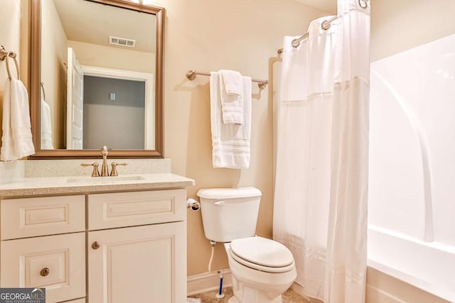 full bathroom featuring vanity, shower / tub combo, and toilet