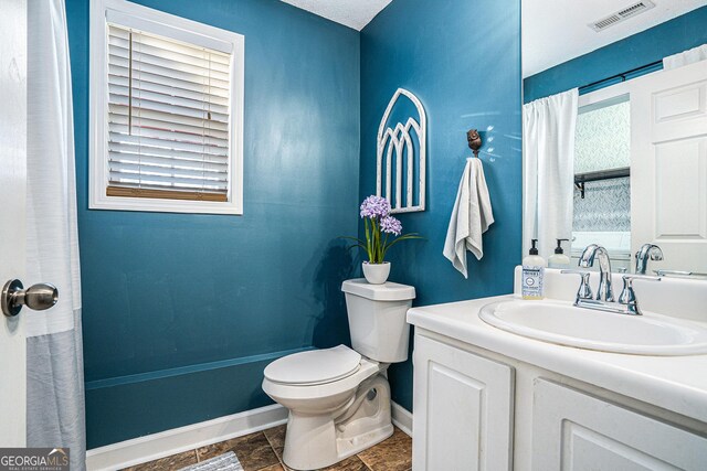 bathroom featuring toilet and vanity