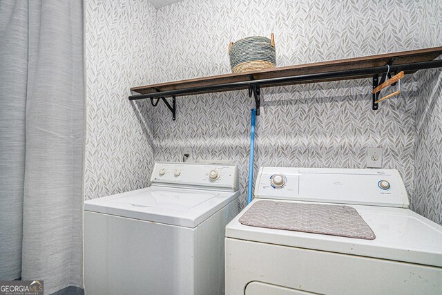 laundry area with washing machine and clothes dryer