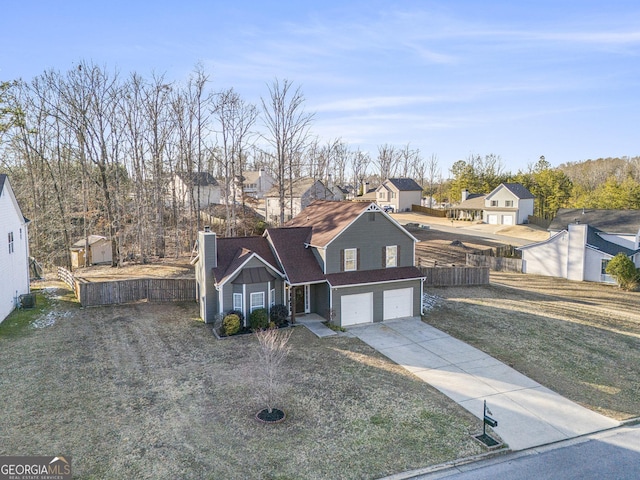 view of front of house with a garage and a front lawn