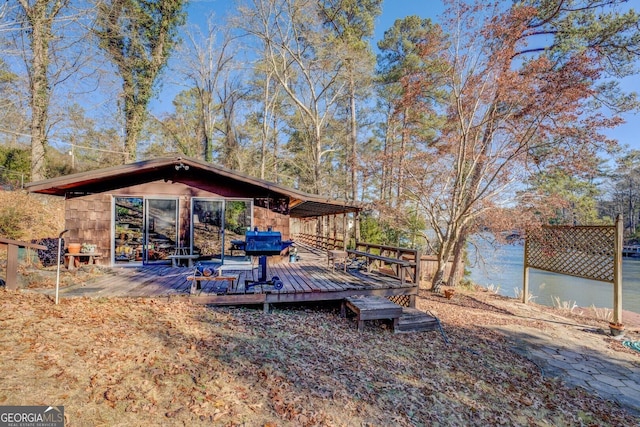 view of yard with a deck with water view