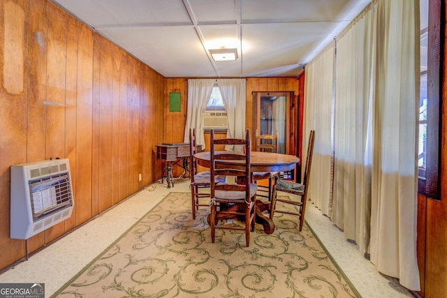 dining room featuring cooling unit, wood walls, and heating unit