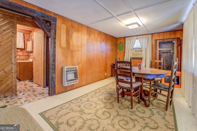 dining space with heating unit, wooden walls, and cooling unit