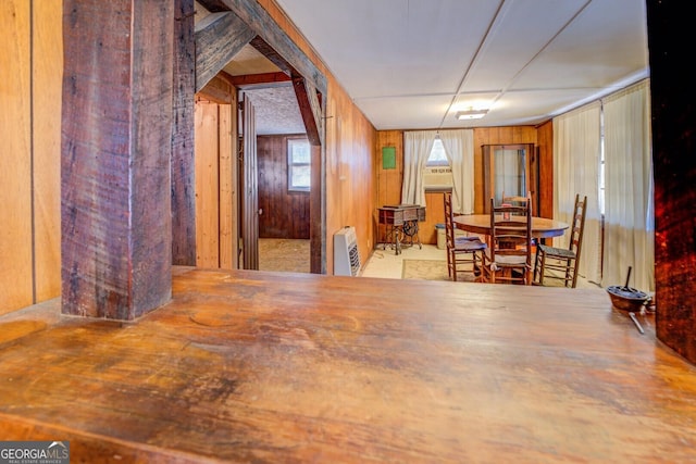 dining space featuring wood walls