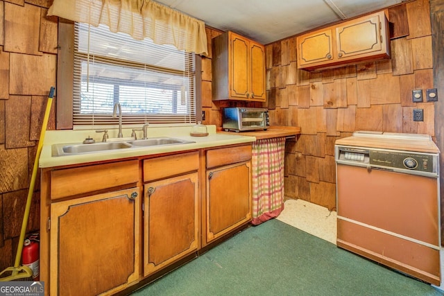 kitchen featuring dark colored carpet and sink