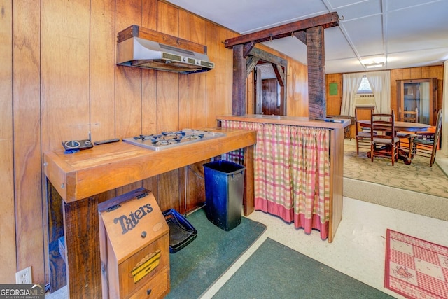 game room with bar area and wood walls