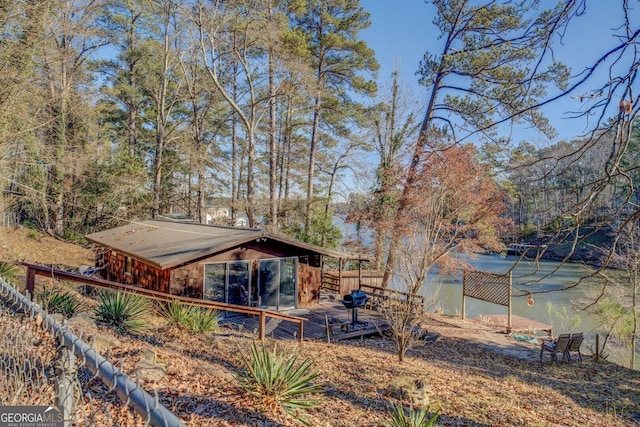 view of yard with a deck with water view