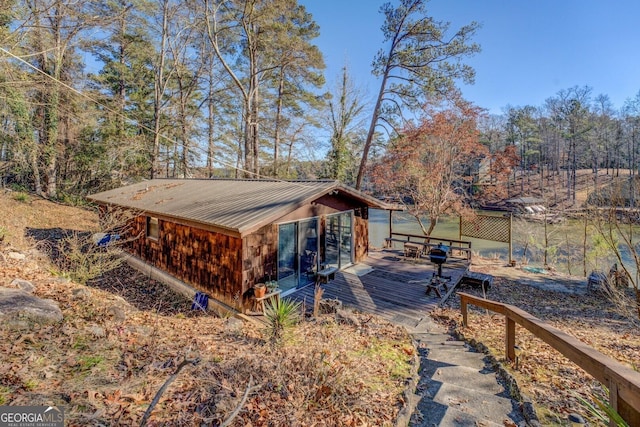 view of property exterior with a wooden deck