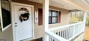 doorway to property featuring a porch