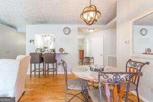 dining area with light wood-style floors and visible vents