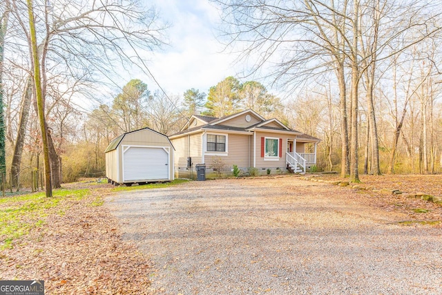 view of front of property with a porch, a garage, and an outdoor structure