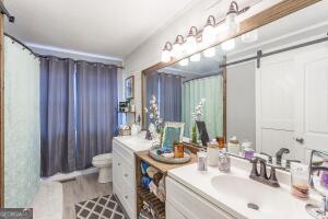 full bath with wood finished floors, vanity, and toilet