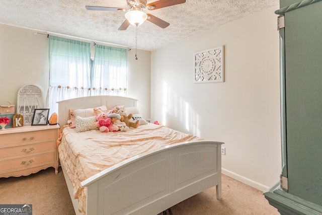 bedroom with carpet flooring, a textured ceiling, and ceiling fan