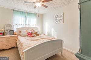 bedroom featuring baseboards, a ceiling fan, and a textured ceiling