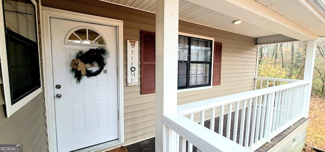 view of exterior entry featuring a porch