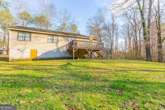 back of property with a lawn and a deck