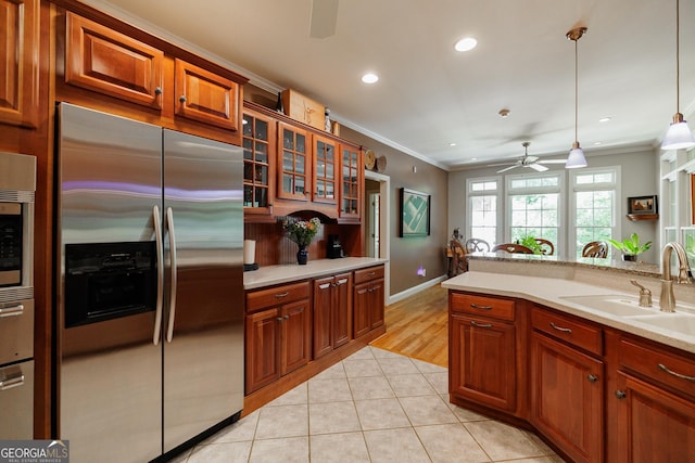 kitchen featuring pendant lighting, stainless steel built in fridge, sink, ceiling fan, and light tile patterned floors