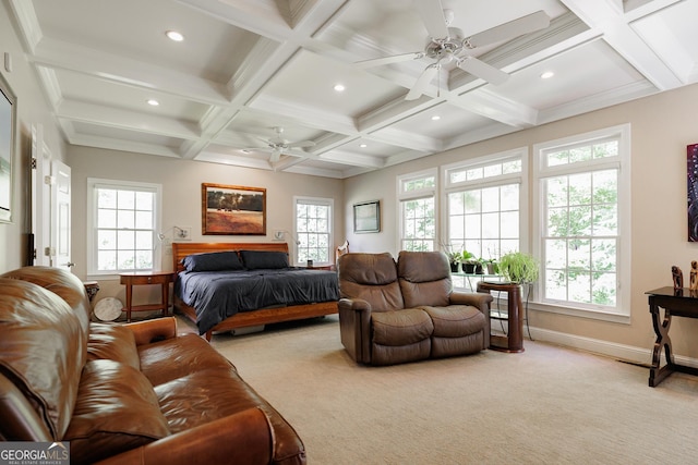 bedroom featuring beam ceiling, multiple windows, ceiling fan, and light colored carpet