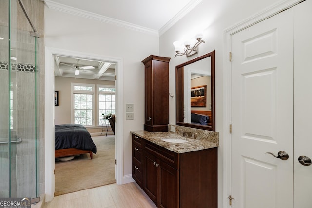 bathroom featuring ornamental molding, coffered ceiling, vanity, ceiling fan, and beam ceiling