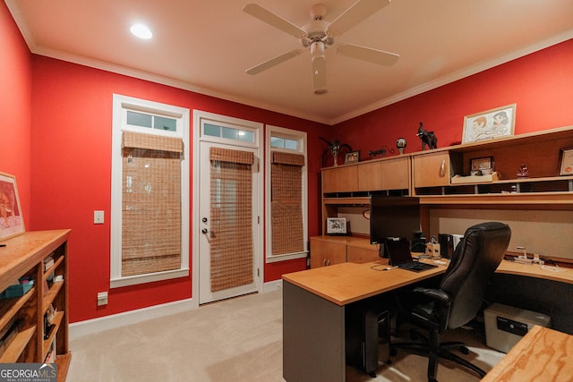 carpeted office featuring ceiling fan, built in desk, and ornamental molding