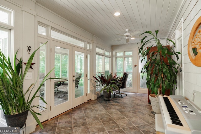 sunroom / solarium featuring heating unit, ceiling fan, wood ceiling, and french doors