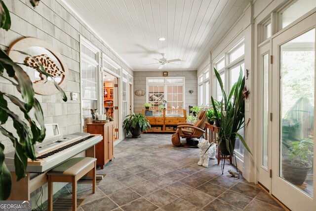 sunroom / solarium featuring ceiling fan and french doors