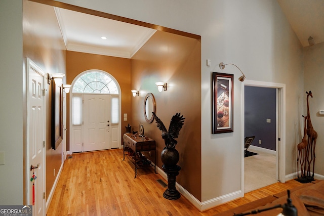 entrance foyer with light hardwood / wood-style floors and ornamental molding