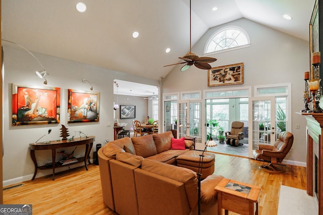 living room featuring ceiling fan, french doors, high vaulted ceiling, and light hardwood / wood-style flooring