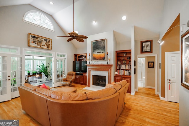 living room featuring french doors, light wood-type flooring, and a wealth of natural light