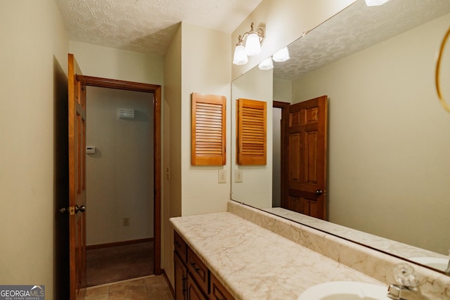 bathroom with vanity and a textured ceiling