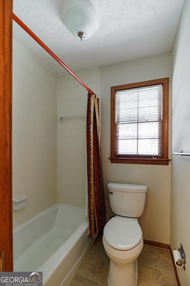 bathroom with tile patterned floors, toilet, a textured ceiling, and shower / tub combo with curtain