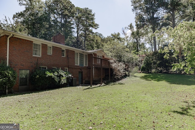 view of yard with central AC and a wooden deck