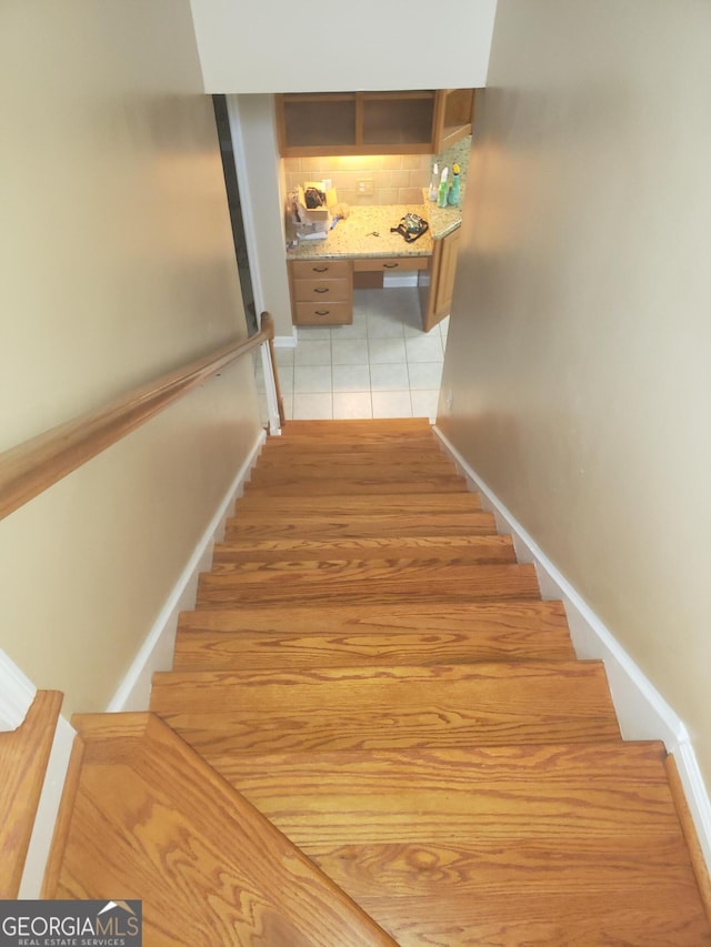 stairs with tile patterned flooring and built in desk