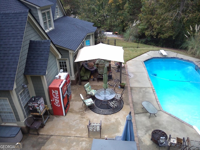 view of swimming pool with a patio and a diving board