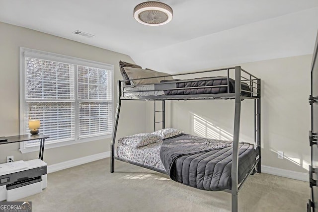 bedroom with light carpet and vaulted ceiling