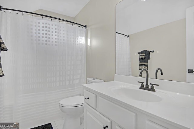 bathroom with tile patterned floors, vanity, and toilet