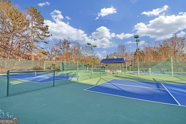 view of tennis court with basketball hoop