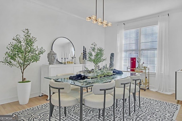 dining room featuring ornamental molding, a healthy amount of sunlight, and light hardwood / wood-style floors