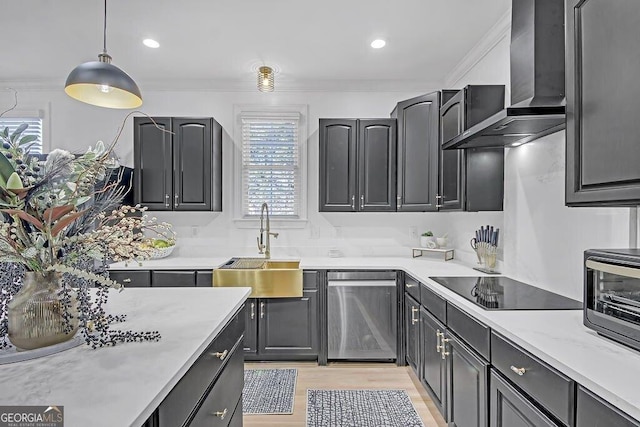 kitchen featuring dishwasher, wall chimney range hood, sink, ornamental molding, and decorative light fixtures