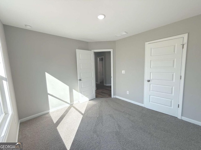 unfurnished bedroom with carpet floors and a closet