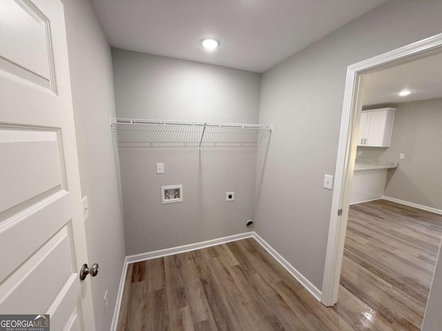 laundry room with washer hookup, electric dryer hookup, and wood-type flooring