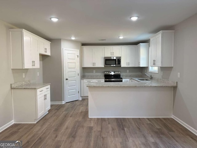 kitchen featuring light stone countertops, sink, white cabinetry, and stainless steel appliances