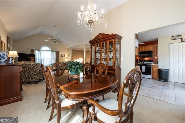 carpeted dining area featuring ceiling fan with notable chandelier and lofted ceiling