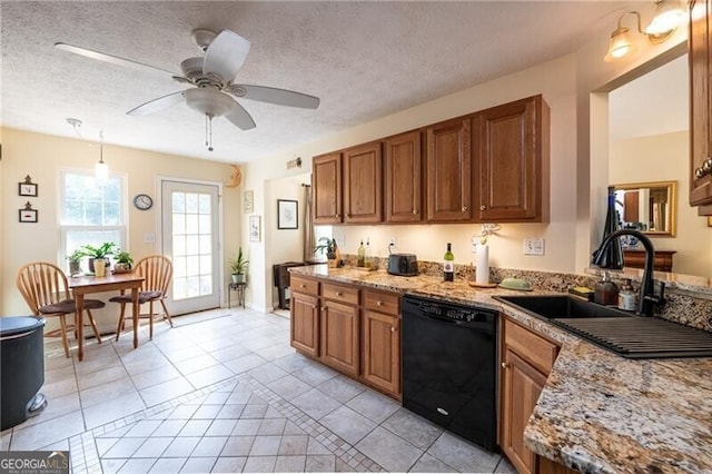 kitchen featuring a textured ceiling, decorative light fixtures, light tile patterned flooring, and black dishwasher